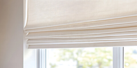 A stylish and modern folded off-white window blind provides diffused light and privacy. Soft, elegant design for a bright and airy atmosphere in any space.