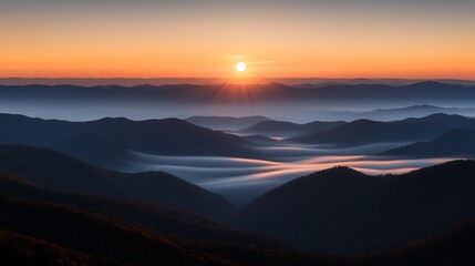 Fototapeta premium Sunrise over misty mountain range.