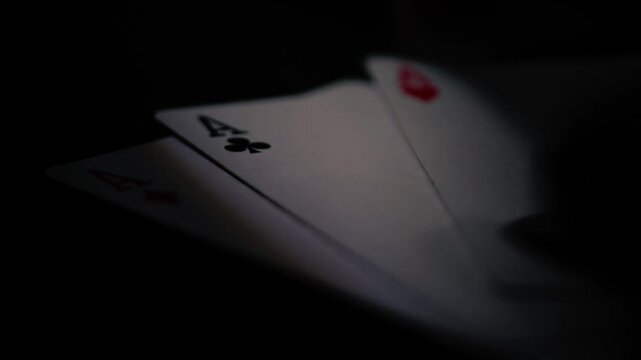 Poker player holding aces playing cards 