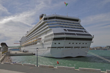 Modern mega cruiseship cruise ship liner Fortuna docked in Malaga, Spain with beach and coast line...