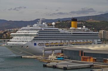 Modern mega cruiseship cruise ship liner Fortuna docked in Malaga, Spain with beach and coast line...