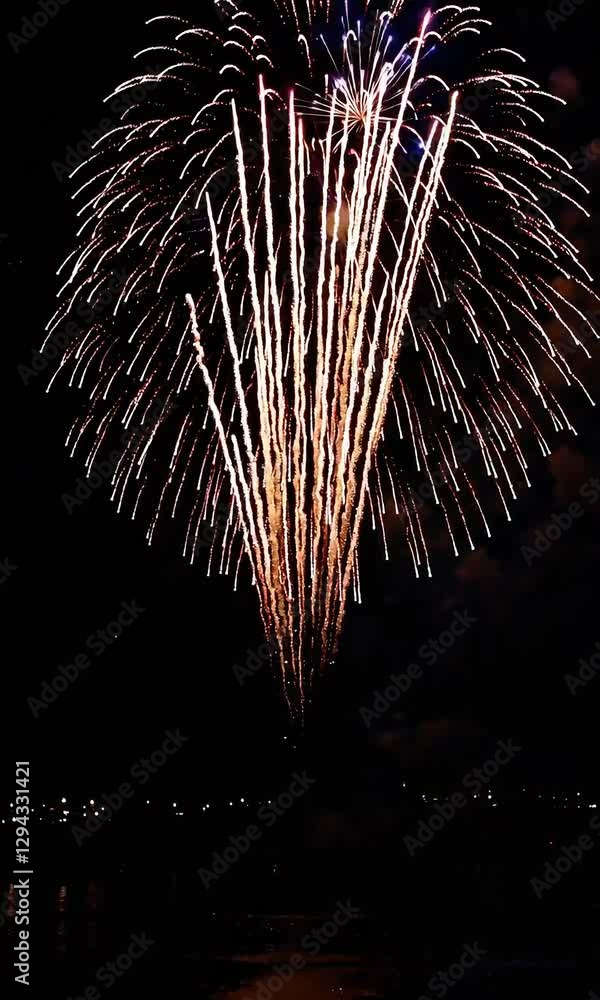 Poster spectacular fireworks exploding over water creating brilliant nighttime display