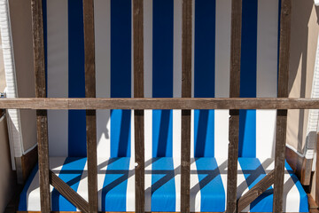 Strandkorb providing shelter from sun and wind. Hooded Wicker beach chairs on a beach at the baltic...