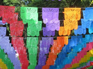 traditional mexican colorful paper garlands in the wind (papel picado)