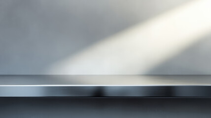 A sleek silver steel countertop with a smooth, reflective surface, set against a gray background with soft spotlighting. Kitchen counter, design is perfect for product displays.
