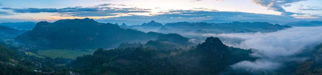 Aerial view A breathtaking view of dawn breaking over a misty mountain landscape, with layers of...