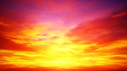 Obraz premium A mesmerizing sunset sky filled with rich and vivid colors, transitioning from deep oranges to vibrant pinks and purples as the sun sets.