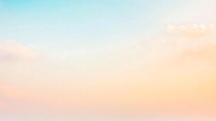 Obraz premium A beautiful sunset sky bathed in golden light, with delicate clouds floating across the sky, creating a soft, dreamy atmosphere perfect for relaxation.