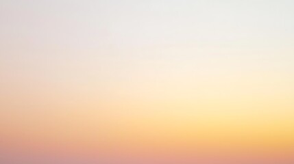 A beautiful sunset sky with a smooth gradient transitioning from warm yellow to soft pink hues, casting a calm glow.