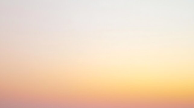A beautiful sunset sky with a smooth gradient transitioning from warm yellow to soft pink hues, casting a calm glow.