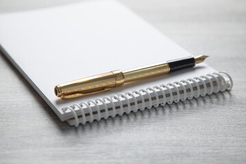 Notepad, pen, with a different business objects on the table.