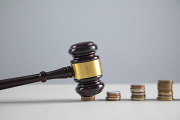 Judge gavel and coins on the table.