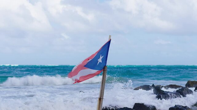 Puerto Rican Flag flapping in slow-motion on a tropical San Juan Beach. Condado Beach, Puerto Rico.