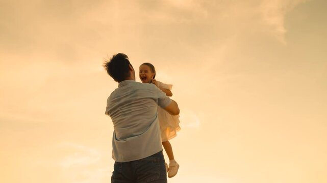 father throws child kid daughter into sky, silhouette happy family, children dream flying airplane pilot, family silhouette against sunset, daughter flying high, family twilight play, child in sky