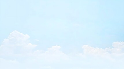 A light, pale blue sky dotted with gentle wisps of clouds, creating a tranquil and airy scene.