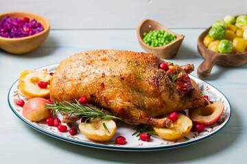 Roasted duck with apples and cranberries served with peas, red cabbage and potatoes