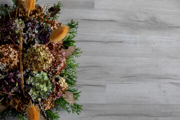 Abeautifully dried floral arrangement elegantly placed on a gray wooden surface