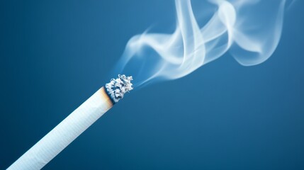 A lit cigarette rests in a dimly lit setting, releasing swirling wisps of smoke that dance gracefully into the air. The moment captures a sense of solitude and contemplation
