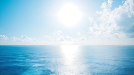 A vast, clear sky with the sun shining intensely, free of any clouds, creating a bright and warm atmosphere.