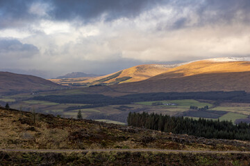 Fototapeta premium Expansive view of Loch Lomond Trossachs Scotland national park in winter with snow Highlands