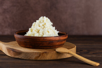 Edible fresh shea butter in a plate on wooden board.
