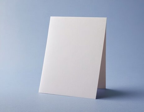 A blank, upright greeting card on a soft blue background.
