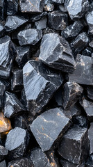 Dark grey stones piled outdoors, close-up texture