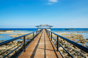 Fototapeta premium Panorama of wild beach and long pier near city Famagusta, Cyprus