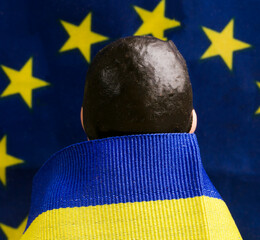 figurine of the president of ukraine in the flag of the country against the background of the us...