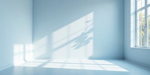 Obraz premium Serene Room Interior with Sunlight Streaming Through Window Casting Leaf Shadows on Pale Blue Walls
