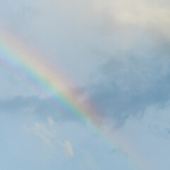Dramatic blue clouds and rainbow in sunset sky. Amazing sky landscape. The sky that gives happiness and peace