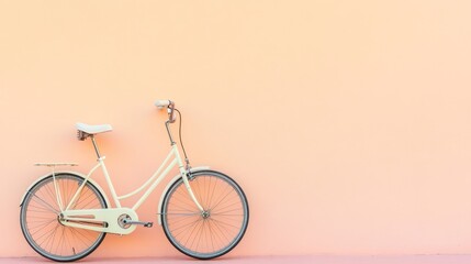 Fototapeta premium A minimalistic white bicycle placed on a soft peach gradient wall
