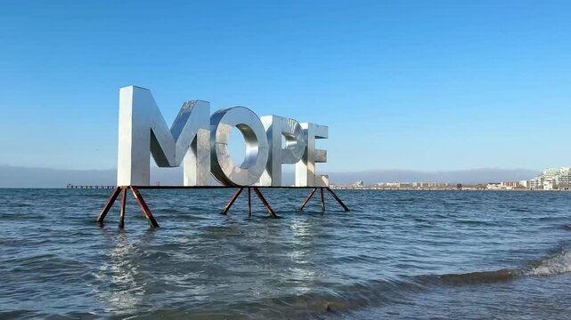 the inscription sea in capital letters in Russian, installed in the Black Sea. An art object with the inscription "SEA" can be seen on the Anapa embankment.