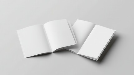 Three open white books lie on a smooth gray surface, showcasing a blank page in each, inviting creativity and exploration.