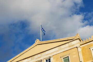 Country's blue and white flag is flying over the Greek Parliament building.