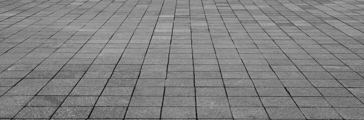 gray granite tiles floor pattern texture perspective view background. grey tiled floor backdrop. grey tile floor background in perspective view. line texture. street, empty copy space. tiled flooring