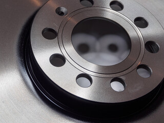 Close-up detail of a metal brake disc, showcasing intricate patterns and textures. Industrial...
