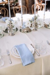 Seating for guests at a table in a restaurant on a terrace in summer. Sunlight and dishes on the table luxury decor