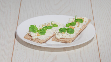 Sliced seeded bread with a golden crust on a light wooden table, perfect for breakfast or sandwiches.