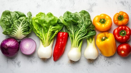 Colorful vegetables - green lettuce, red tomato, white onion, yellow pepper, purple pak choi arranged on a white surface. Healthy eating and cooking concept.