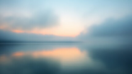 Fototapeta premium A serene, misty lake at dawn reflects the pastel sky, creating a peaceful, dream-like atmosphere with calm waters and a distant horizon.
