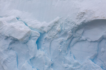 Abstract closeup of details and textures of ice from the wall of an iceberg in Antarctica
