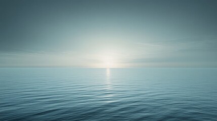 Obraz premium Endless horizon over calm teal waters, misty sky enhancing the serene and infinite beauty of the ocean stretching to the sunlit distance.