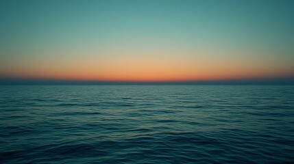 Fototapeta premium A mesmerizing seascape at sunset, where the sun's glow transitions into deep blue, stretching across the horizon, embodying peace and infinity.