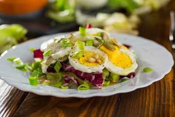 Appetizing egg dish in a plate on a wooden table