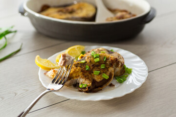 Fish with herbs and lemon on a plate