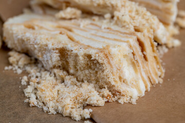 layered cake with white sweet cream on a board
