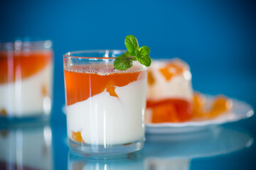 Layered fruit dessert with jelly, cream and fresh mint