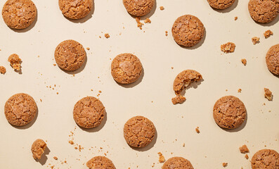 Flat lay of amaretti cookies on beige background with shadow.