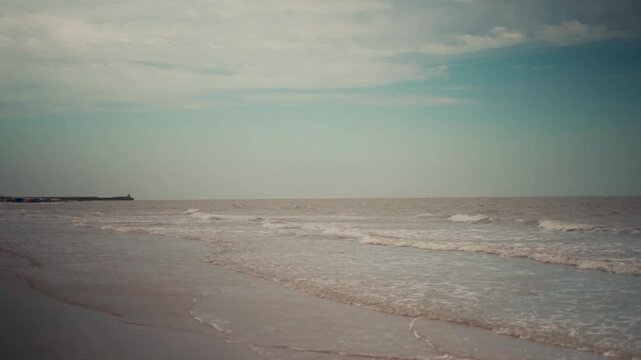 Beach waves on an empty beach with soft daylight